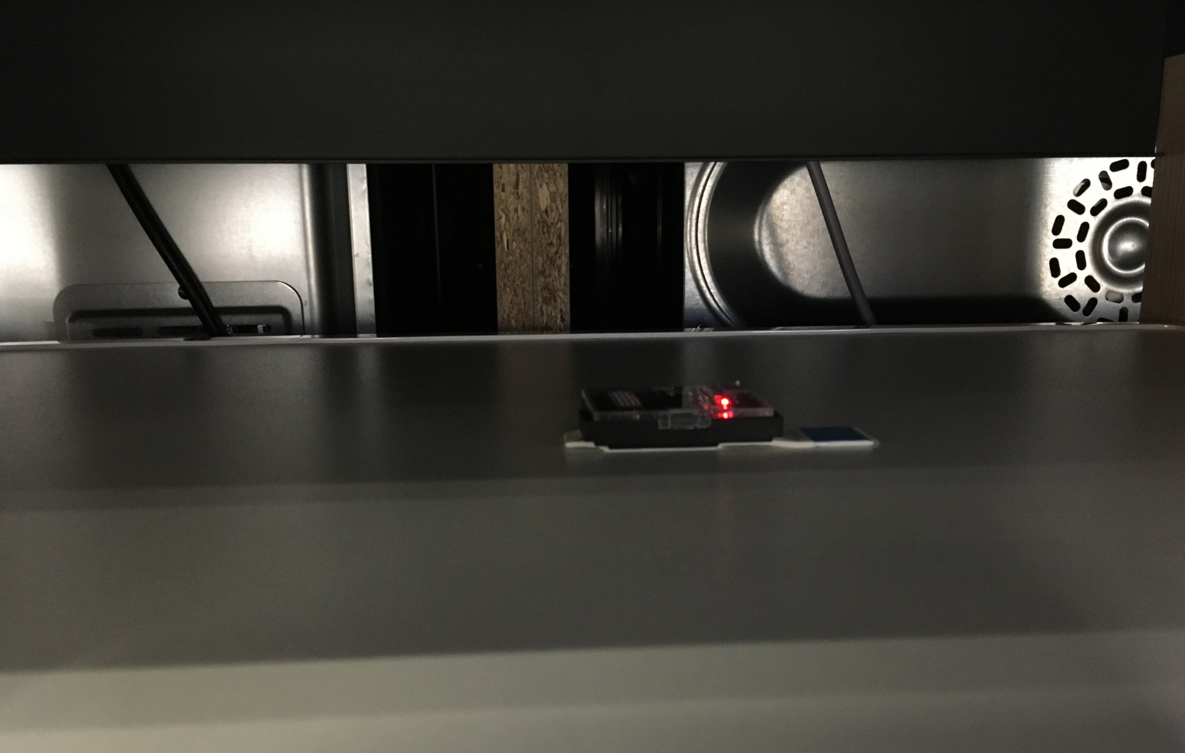 IoT vibration sensor installed on a washing machine in a retail environment